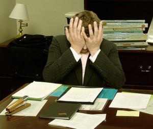 Frustrated_man_at_a_desk_cropped-300x253